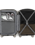 Small cabin suitcase interior in grey with open compartments, straps, and mesh pocket