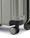 Silver small cabin suitcase showing corner wheels and lower side latch, hard-shell design