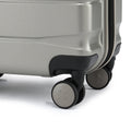 Small cabin suitcase corner with 360° wheel and silver shell, black bumper.