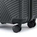 Charcoal grey hard-shell cabin suitcase corner with spinner wheels