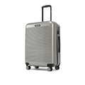HRX check-in suitcase in silver-gray shown from the side with wheels and upright handle