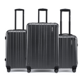 Three dark grey suitcases stacked side-by-side with telescopic handles and spinner wheels