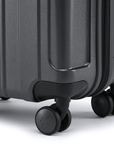 Charcoal grey hard-shell suitcase corner with bumper and 8 rolling wheels