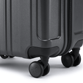Charcoal grey hard-shell suitcase corner with bumper and 8 rolling wheels