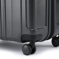 Charcoal grey suitcase close-up of side corner and rolling wheels