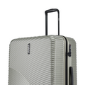 Hard-shell silver suitcase close view of ridged shell and side lock panel