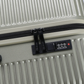 Hard-shell silver suitcase front lock with combination dial and zipper