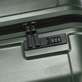 Hard-shell dark green suitcase lock panel with combination keypad and dual zipper pull tabs