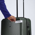 Hard-sided dark green spinner suitcase, ridged front with upright handle and tag label