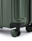 Dark green small cabin suitcase bottom with molded feet and 4 spinner wheels
