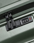Small cabin suitcase with TSA-style combo lock detail on dark green body