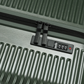 Dark green hard-shell suitcase zipper with dual pulls and built-in lock panel