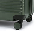 Large check-in suitcase wheel and corner on dark green hard shell
