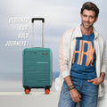 Small cabin suitcase in teal with telescopic handle and 8 wheels, standing upright.