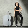 Light blue hard-shell suitcase with telescopic handle and four spinner wheels