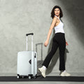 White hard-shell cabin suitcase on four wheels with telescopic handle, with model