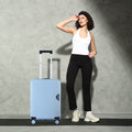 Light blue hard-shell carry-on suitcase with retractable handle and spinner wheels
