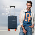 Small cabin suitcase, navy blue hard-shell spinner with 8 wheels and orange accents