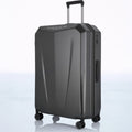 Hard-shell trolley luggage in dark blue with telescopic handle and four spinner wheels.