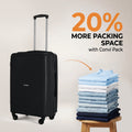 Black hard-shell suitcase with telescopic handle and 4 wheels beside folded packing clothes.