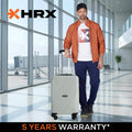 Light hard-shell suitcase with telescopic handle and four wheels, upright