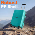 Medium hard-shell suitcase with telescopic handle, four wheels, teal on rocky surface.