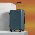 HRX medium polypropylene suitcase in teal, standing upright on four wheels