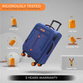 Blue soft body spinner trolley luggage shown tilted, with orange wheels and stitched panels