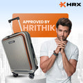 Silver hard-shell trolley suitcase with side handle and orange edge trim