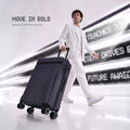 Dark polycarbonate trolley suitcase with carry handle and 8 spinner wheels, angled front view