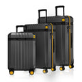 Set of three dark grey polycarbonate trolley suitcases with yellow-trim handles and wheels