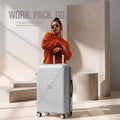 Light gray cabin spinner suitcase with ribbed shell, four 360 wheels, and handle