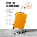 Yellow large suitcase with damage-testing scene and 5-year warranty badge