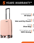 Peach cabin suitcase with black handle and 8 spinner wheels on display.