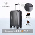 Dark gray hard shell trolley suitcase with telescopic handle and carbon fiber finish