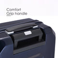 Hard-shell polycarbonate trolley suitcase comfort grip handle close-up, dark blue