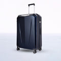 Hard-shell polycarbonate trolley suitcase in dark blue, upright with wheels visible