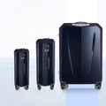 Hard-shell trolley luggage set of three sizes with upright shells and four spinner wheels.