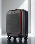 Small cabin suitcase with 8 wheels, dark panels, silver front grille, zip top