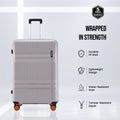 Grey hard-shell suitcase with telescopic handle and four spinner wheels