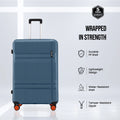 Hard-shell spinner luggage in dark blue with telescopic handle and orange 4-wheel base