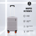 Grey cabin suitcase with telescopic handle, orange-trim accents, and spinner wheels