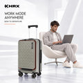 Silver hard-shell laptop cabin trolley with front zipper, orange trim, 4 spinner wheels.