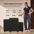 Large check-in suitcase set in dark color with aluminum handle and four rolling wheels