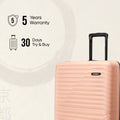 Medium check-in suitcase in peach with telescopic handle and ridged shell