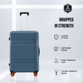Blue hard-shell suitcase with top handle and four spinner wheels, side view