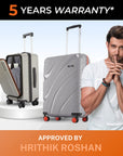 Medium grey hard-shell spinner suitcase with open laptop compartment and red wheels