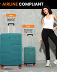 Teal hardshell large and cabin trolley suitcases side by side with telescopic handles.