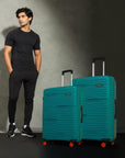 Teal hard-shell upright luggage set with telescopic handle and orange spinner wheels