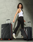 Medium black hard-shell trolley suitcase set with red wheels and front laptop pocket